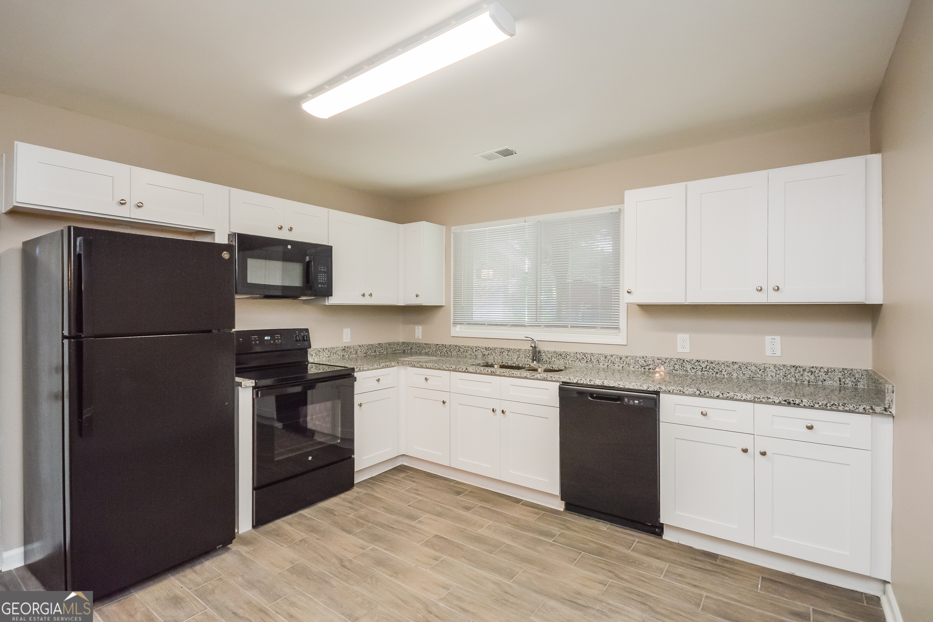 1534 Flicker Road Hampton, GA 30228 - Photo 12 of 16 a kitchen with a refrigerator stove and sink