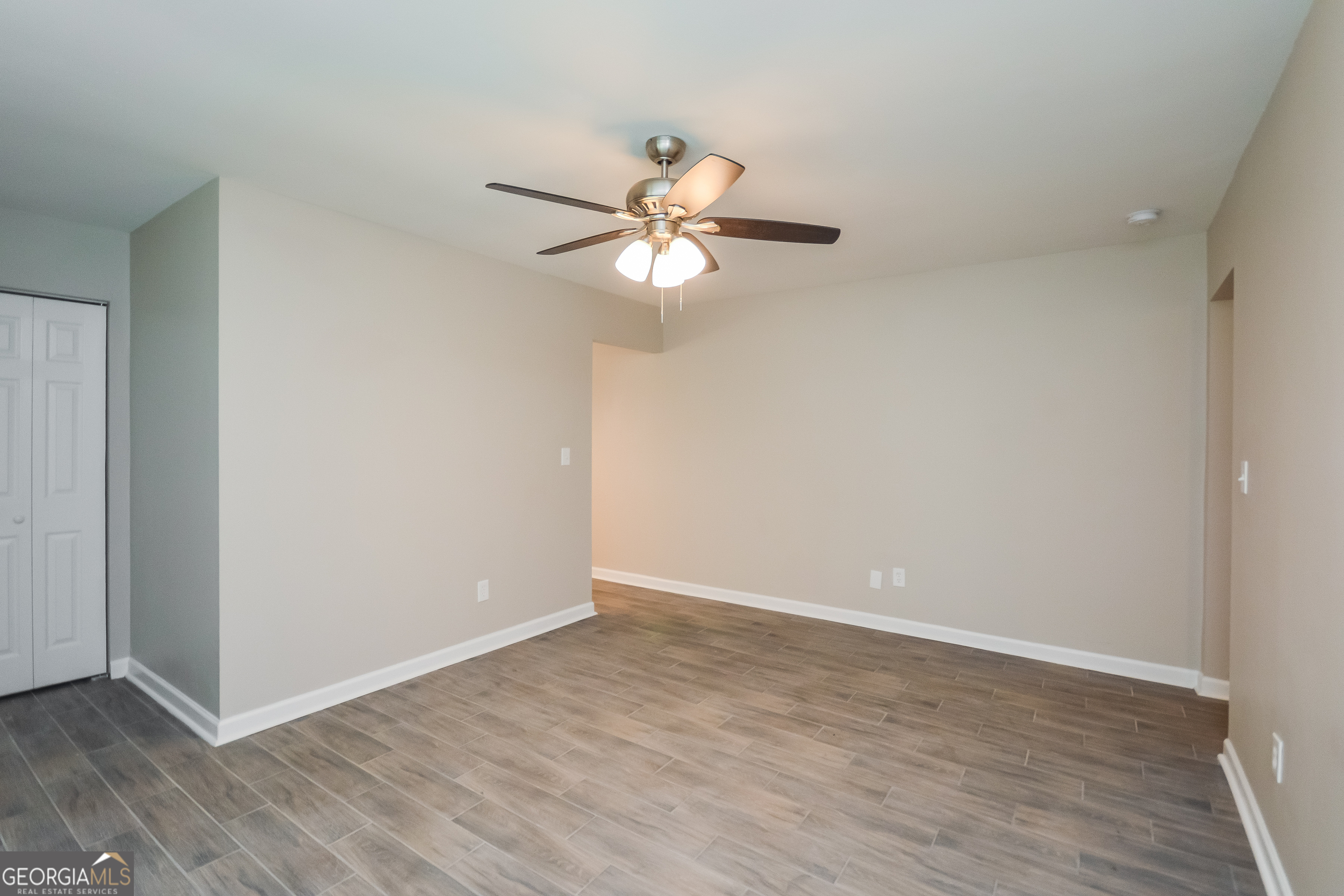 1534 Flicker Road Hampton, GA 30228 - Photo 15 of 16 a view of a room with wooden floor and a ceiling fan