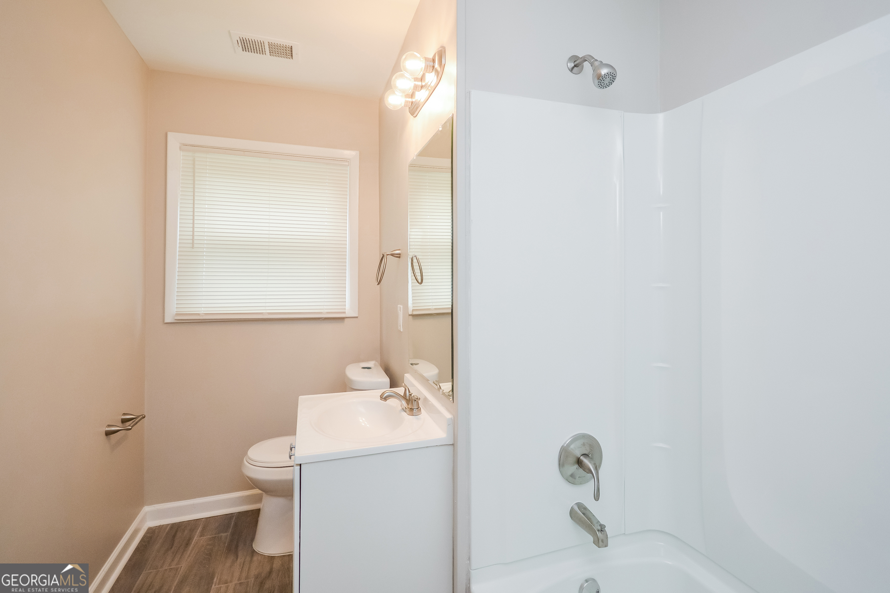 1534 Flicker Road Hampton, GA 30228 - Photo 4 of 16 a bathroom with a sink toilet and shower