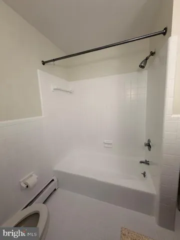a bathroom with a shower and a bath tub