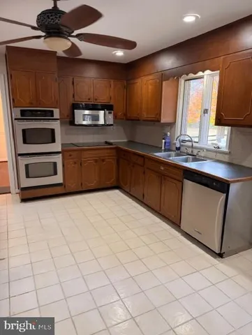 a kitchen with stainless steel appliances a sink and a stove top oven