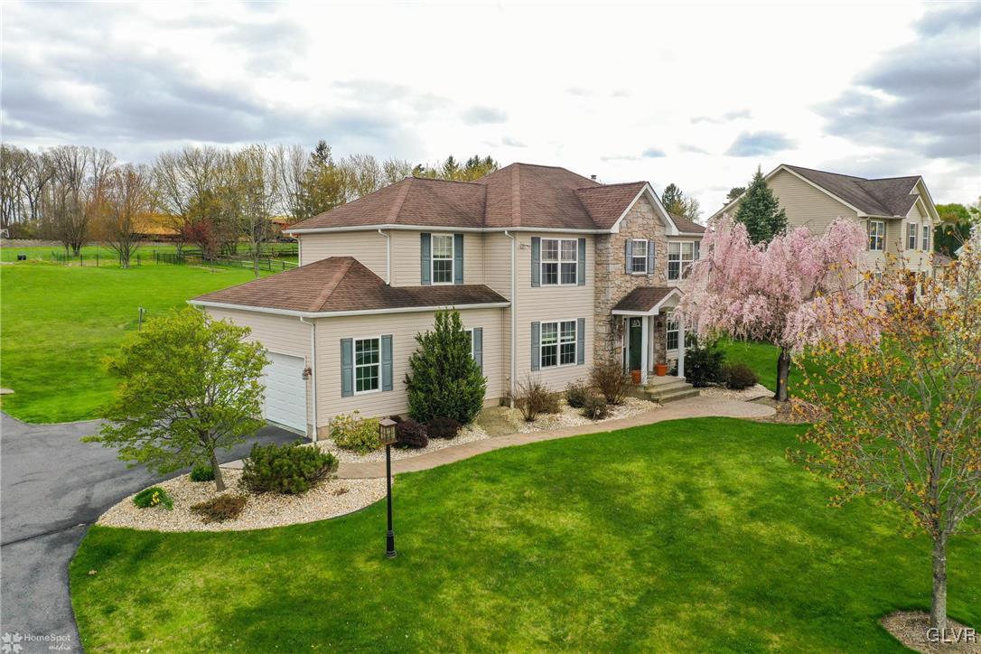 124 Belfast Road Nazareth, PA 18064 - Photo 1 of 35 a view of a white house with a big yard and potted plants