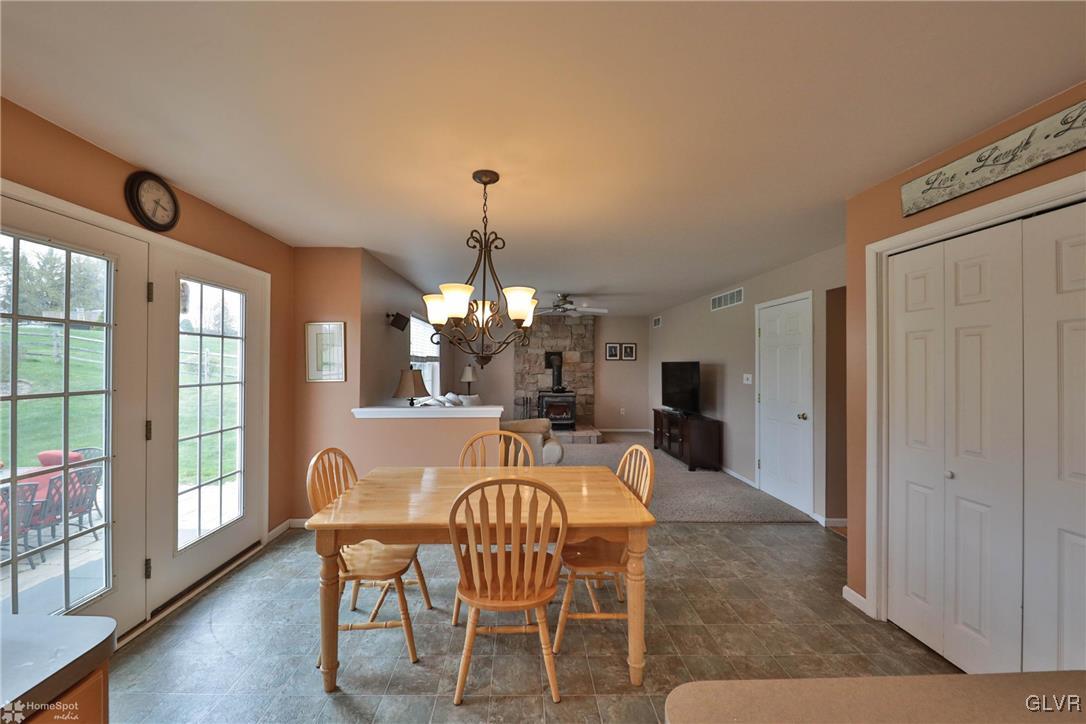 124 Belfast Road Nazareth, PA 18064 - Photo 11 of 35 a dining room with furniture a chandelier and wooden floor