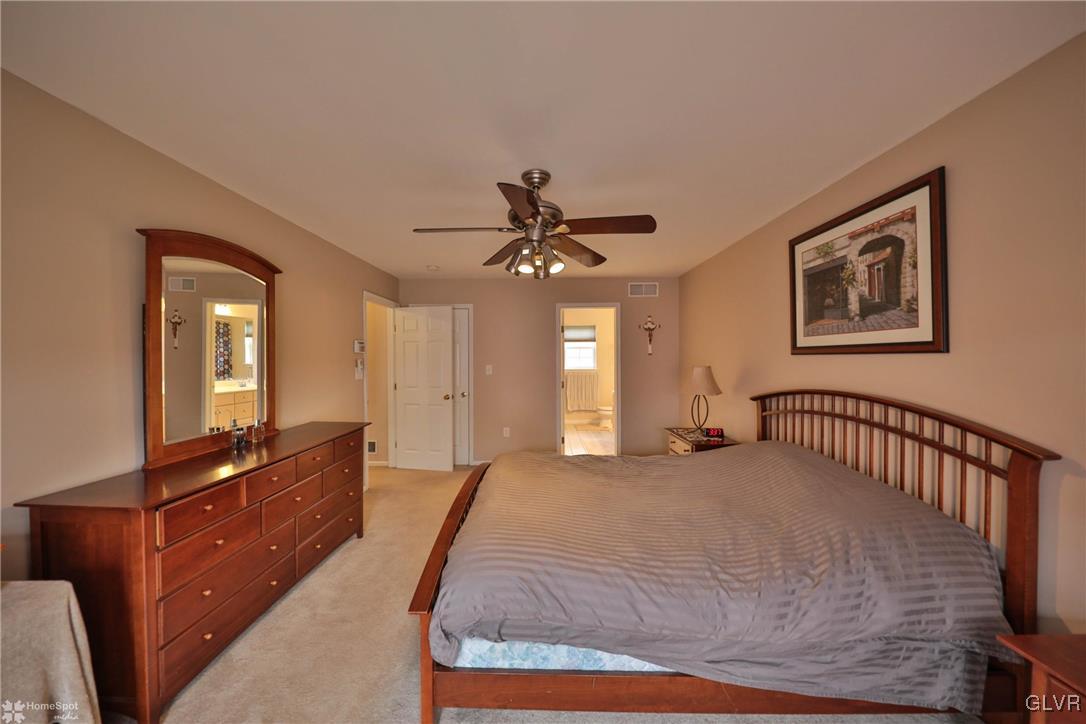 124 Belfast Road Nazareth, PA 18064 - Photo 17 of 35 a bedroom with a bed and a chandelier