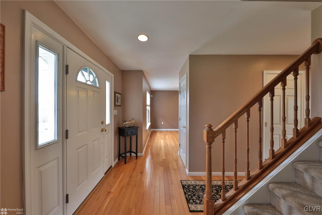 124 Belfast Road Nazareth, PA 18064 - Photo 3 of 35 a view of a hallway with wooden floor and staircase
