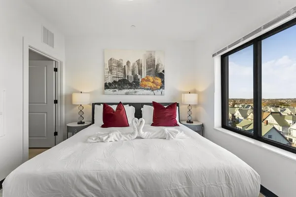 a bedroom with a bed and window