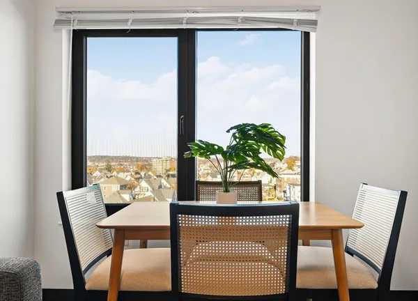 a view of a room with a table and chairs