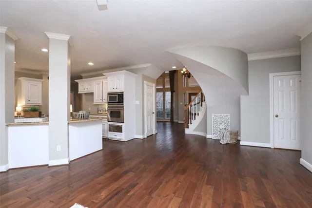a view of a big room with wooden floor windows and a living room