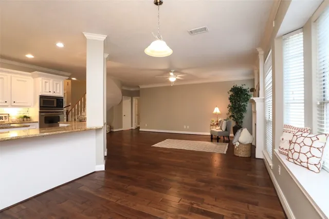 a view of a room with wooden floor and a large window