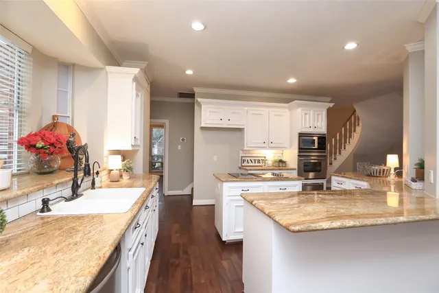 a kitchen with sink stove and refrigerator