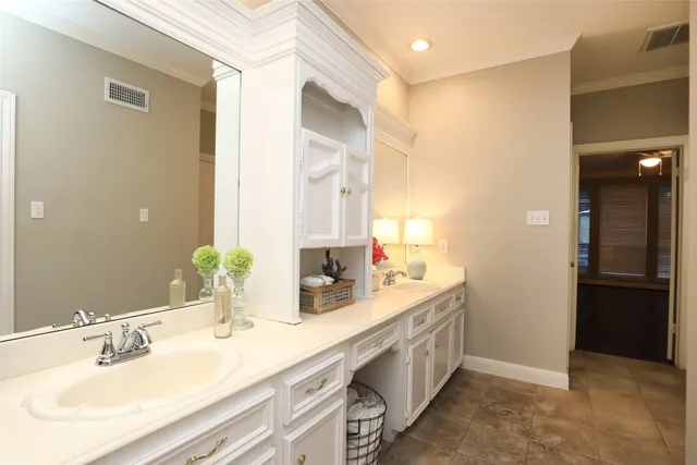 a bathroom with a double vanity sink and a mirror