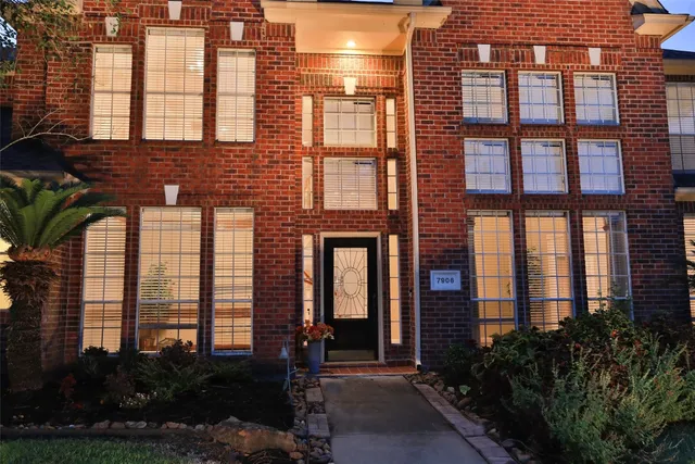 a front view of a building with a garden