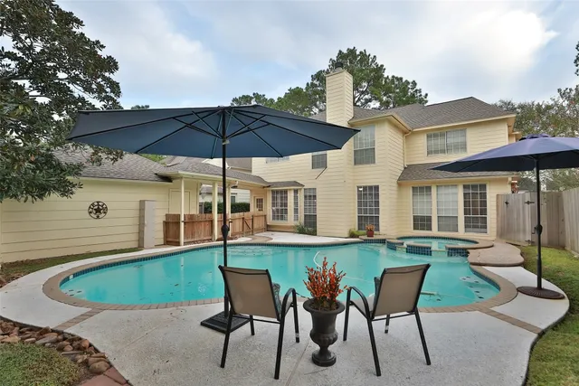a view of a house with backyard sitting area and garden