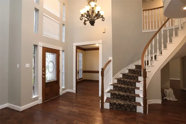 a view of entryway and hall with wooden floor