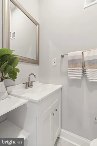 a bathroom with a toilet a sink and glass door