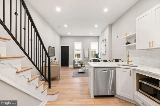 a kitchen with stainless steel appliances kitchen island granite countertop a stove and a sink
