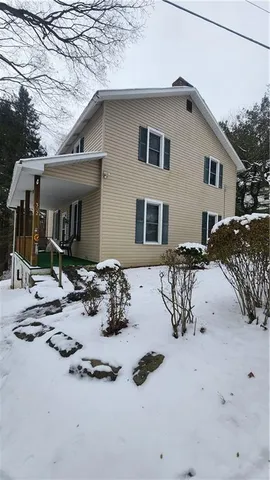 a view of a house with snow on the road
