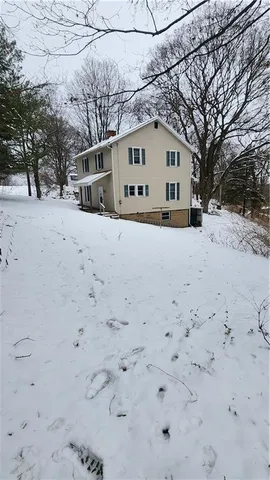a view of white house with a snow on the road