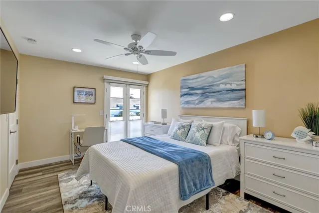 a view of a patio with couches and a table and chairs with wooden fence