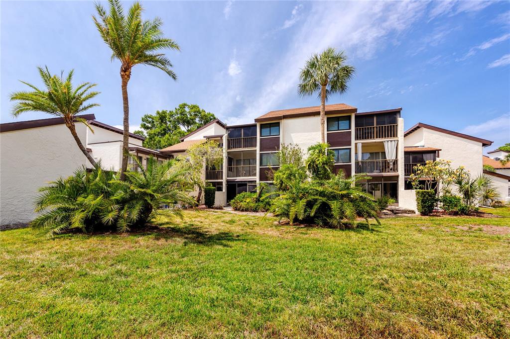 2207 Belleair Road, Unit B30 Clearwater, FL 33764 - Photo 37 of 39 a view of a house with a yard and sitting area