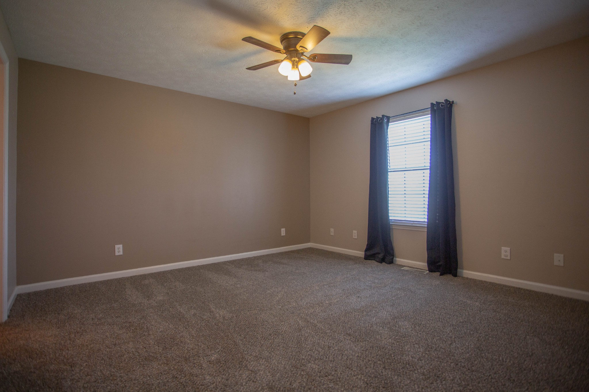 794 Chicken Road Lebanon, TN 37090 - Photo 12 of 25 a view of an empty room with a ceiling fan and window