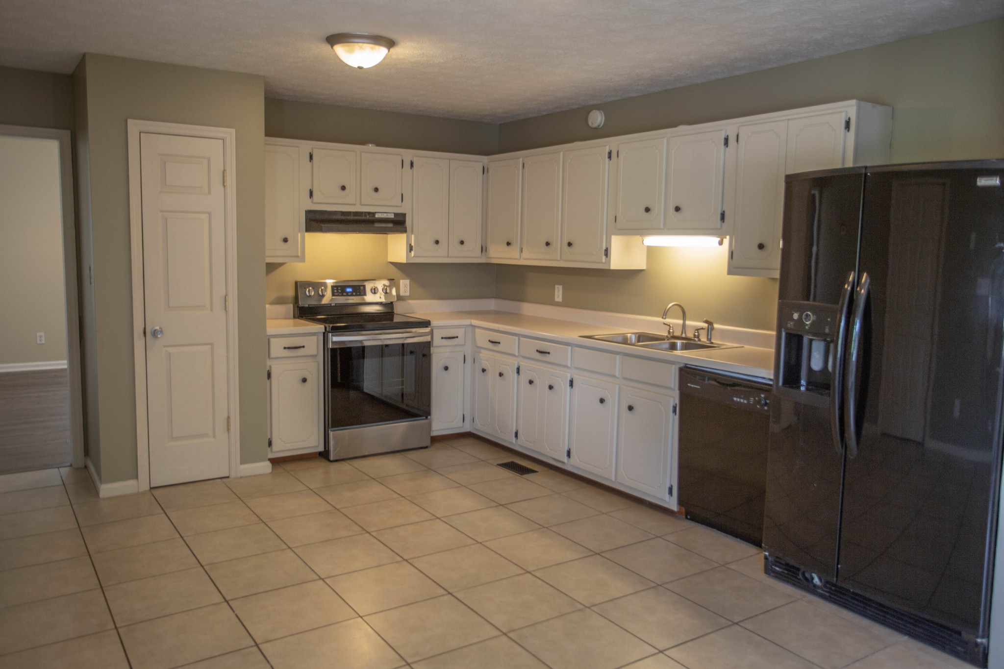 794 Chicken Road Lebanon, TN 37090 - Photo 7 of 25 a kitchen with stainless steel appliances granite countertop a refrigerator sink and cabinets