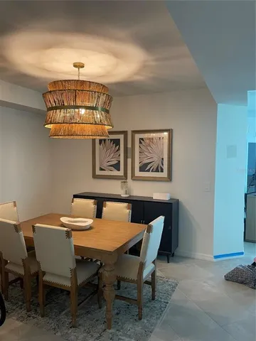 a dining room with furniture and chandelier
