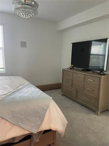 a bedroom with a bed and flat screen tv