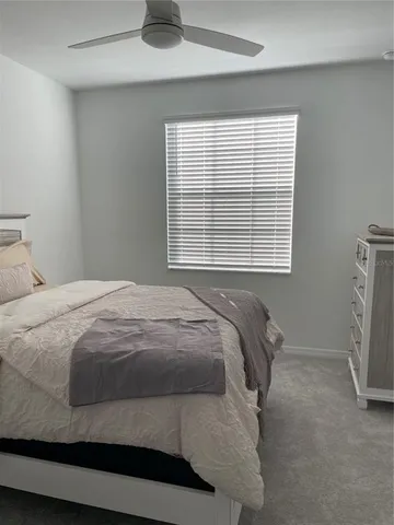 a bed sitting in a bedroom next to a window