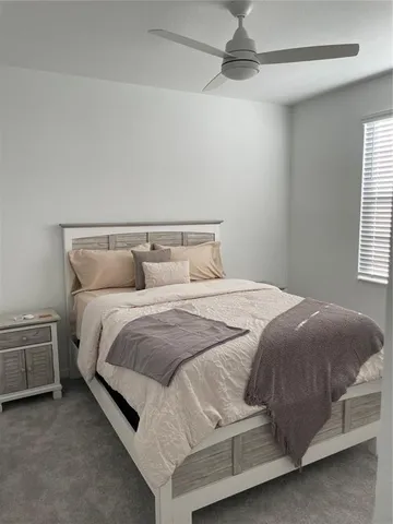 a bedroom with a bed and window