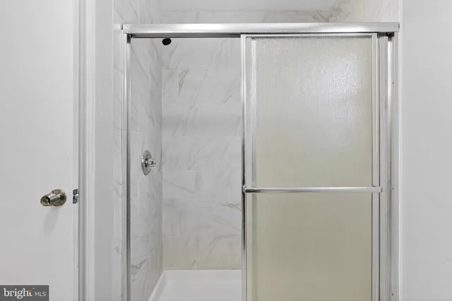 a bathroom with a glass shower door