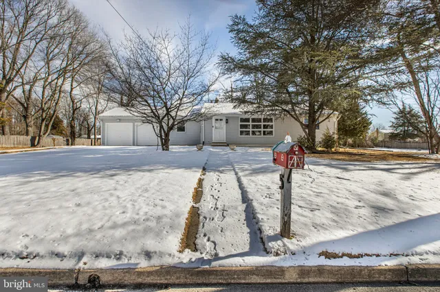 a view of yard covered with snow in front of house