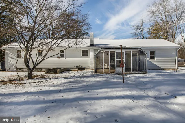 a front view of a house with a trees