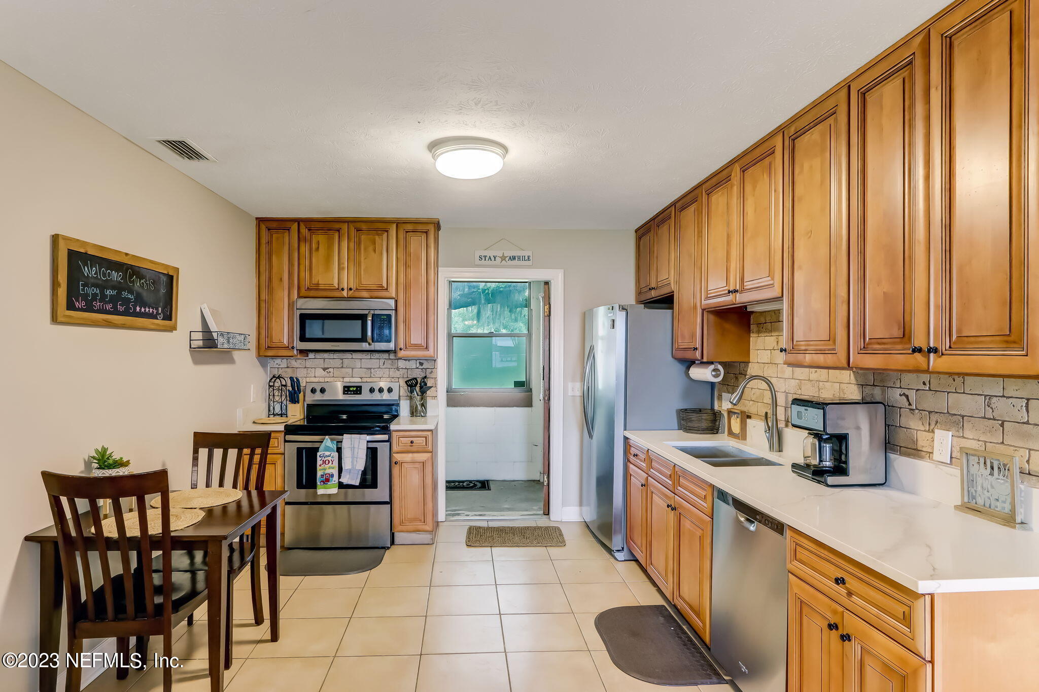259 Brickyard Road, Unit B Middleburg, FL 32068 - Photo 11 of 53 a kitchen with stainless steel appliances a stove a sink a microwave a refrigerator and cabinets