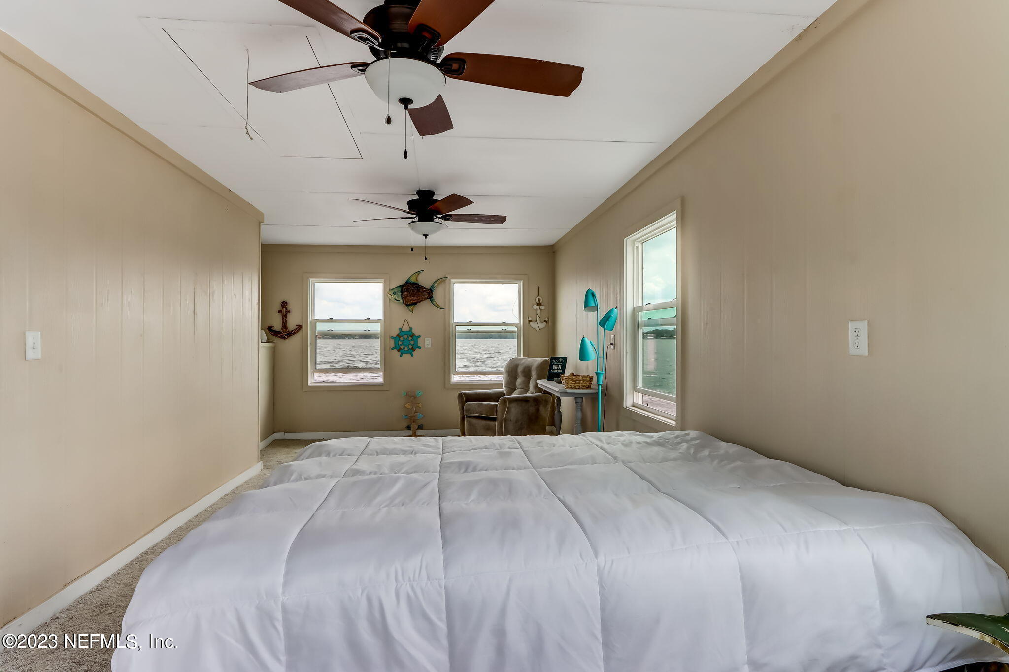 259 Brickyard Road, Unit B Middleburg, FL 32068 - Photo 39 of 53 a spacious bedroom with a large bed and a chandelier fan