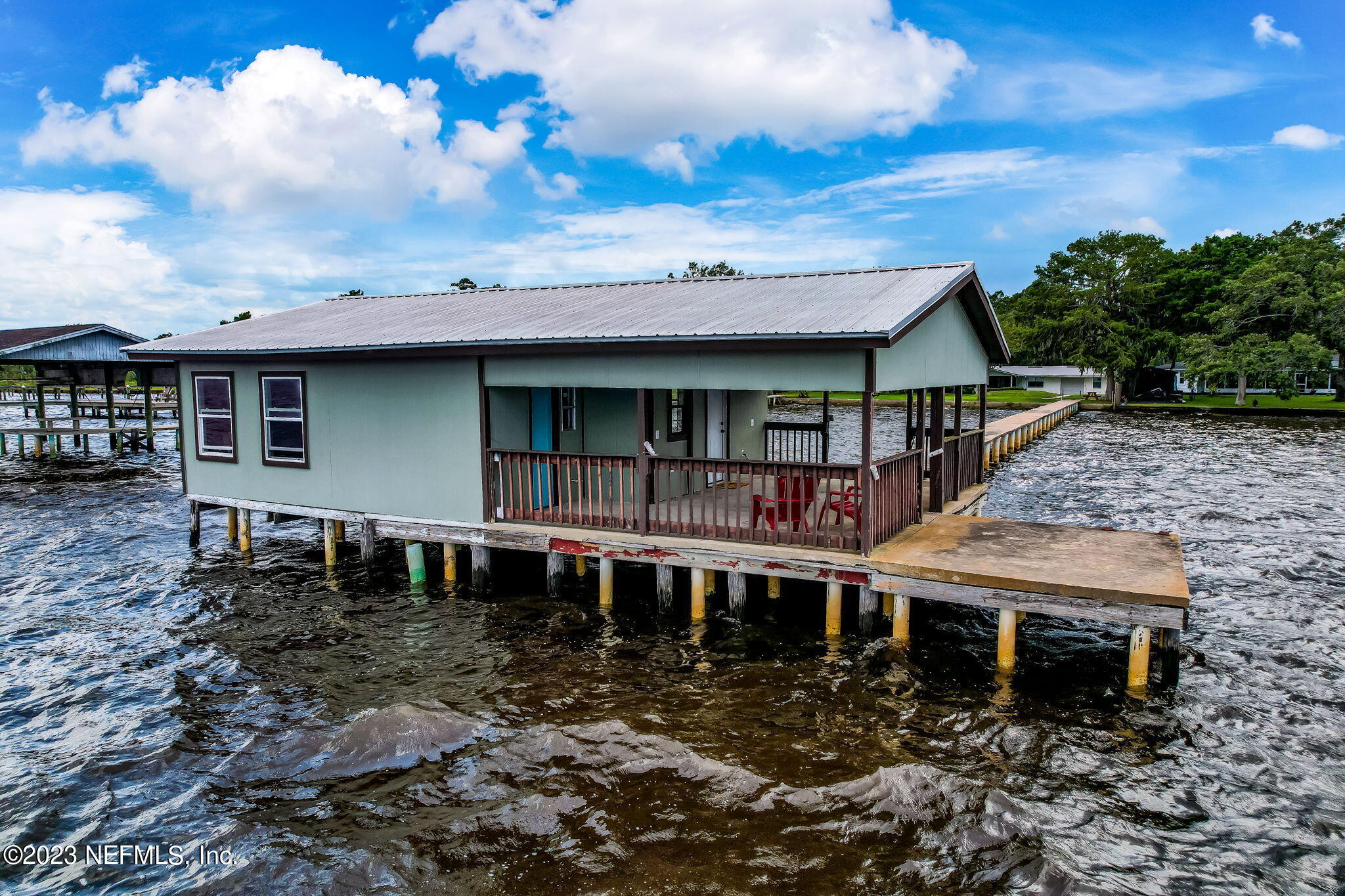 259 Brickyard Road, Unit B Middleburg, FL 32068 - Photo 51 of 53 a view of a house with a wooden deck and a yard
