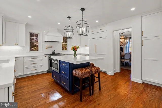a kitchen that has a table chairs and wooden floor