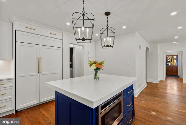 a kitchen with stainless steel appliances a stove a sink cabinets and a refrigerator