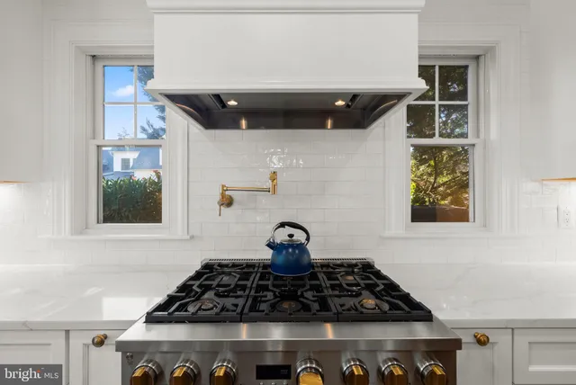 a view of a hallway with wooden floor and livingroom