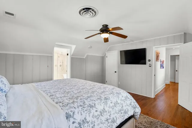 a bedroom with a large bed and a window