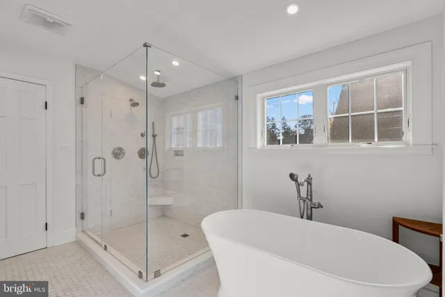 a bathroom with a sink a toilet a mirror and a window