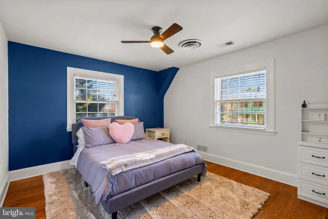 a bedroom with a bed and ceiling fan