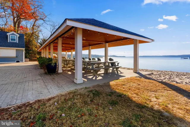 a view of a house with swimming pool and sitting area