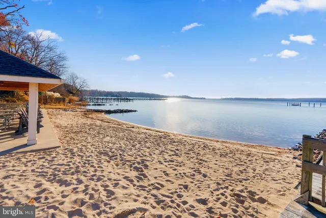 an aerial view of lake residential house with outdoor space and trees all around
