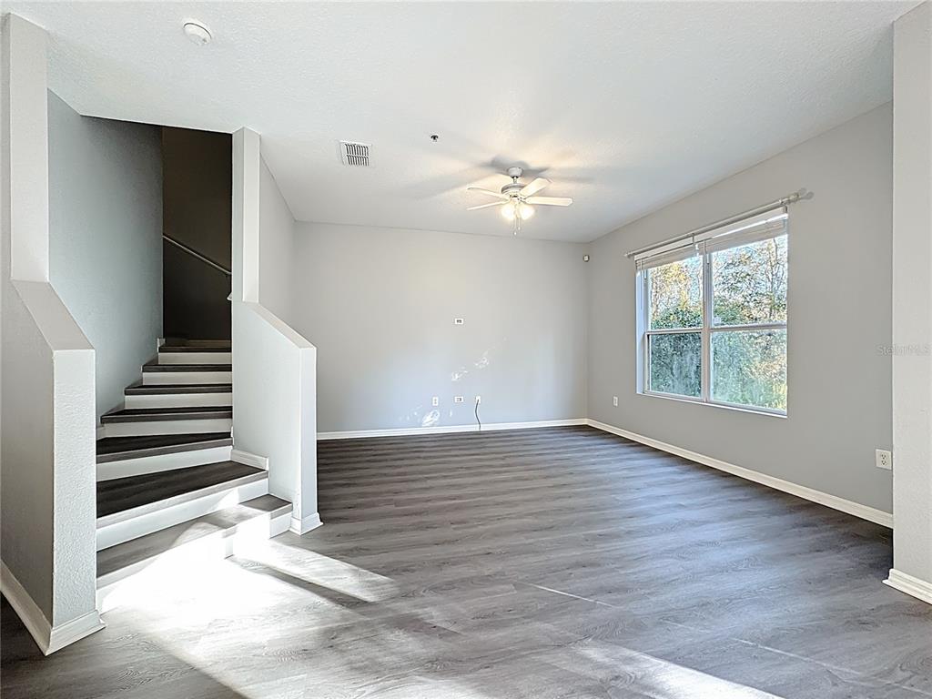 1500 Broken Oak Drive, Unit 25B Winter Garden, FL 34787 - Photo 19 of 62 an empty room with wooden floor and ceiling fan
