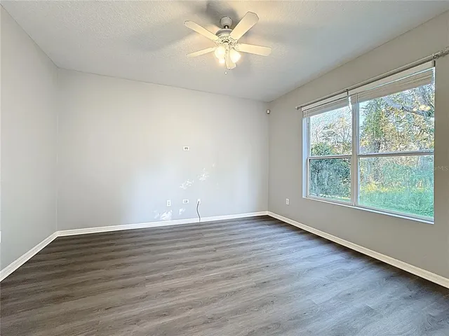 a kitchen with granite countertop white cabinets and a sink