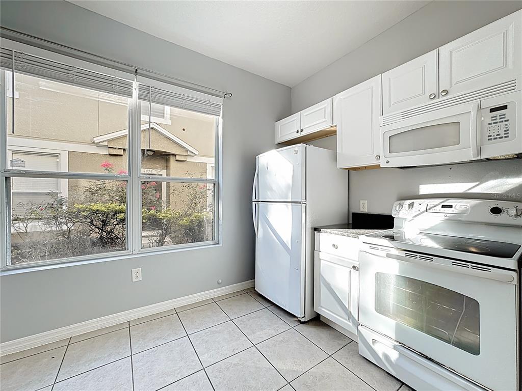 1500 Broken Oak Drive, Unit 25B Winter Garden, FL 34787 - Photo 27 of 62 a kitchen with a stove a refrigerator and a stove