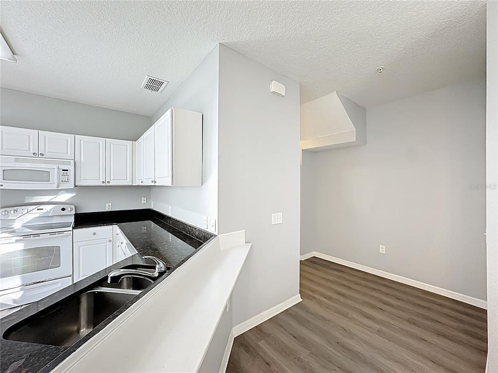 1500 Broken Oak Drive, Unit 25B Winter Garden, FL 34787 - Photo 33 of 62 a kitchen with a sink and white cabinets