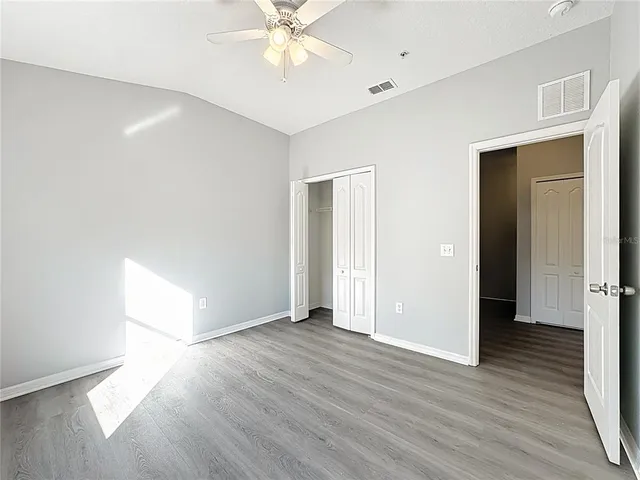 a view of an empty room with wooden floor