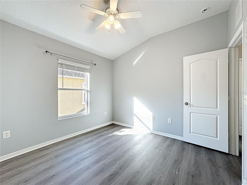 1500 Broken Oak Drive, Unit 25B Winter Garden, FL 34787 - Photo 42 of 62 an empty room with wooden floor fan and windows